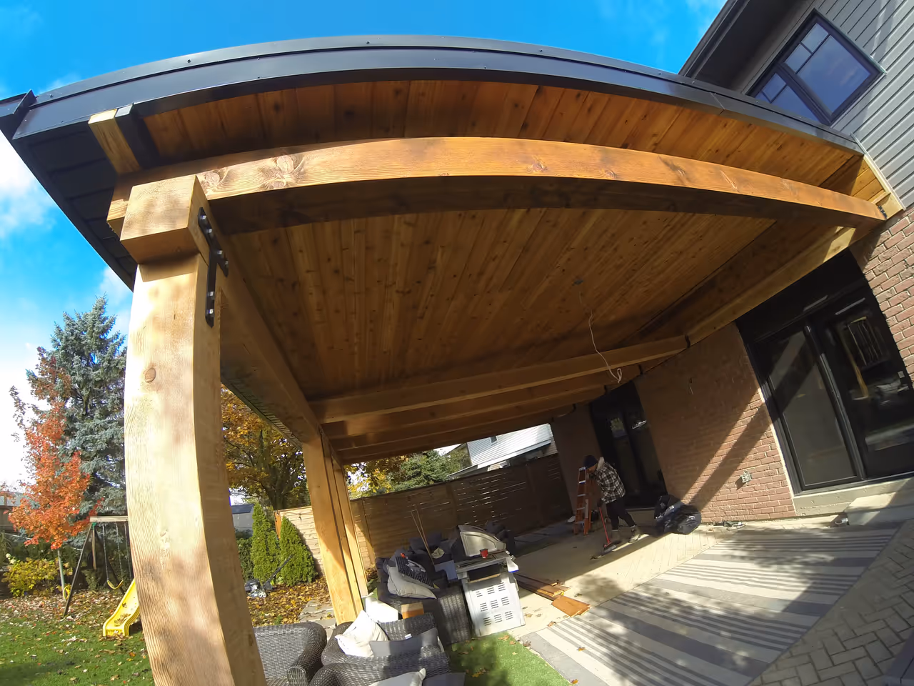 Outdoor wooden patio with roof cover.