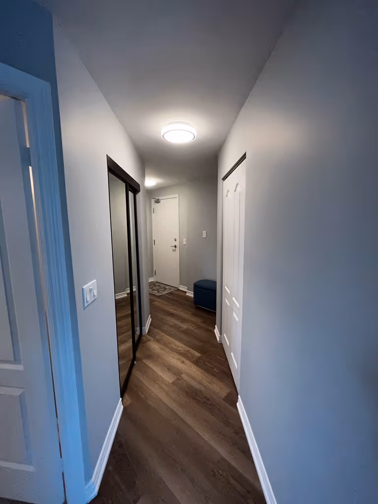 Hallway with door and mirror.