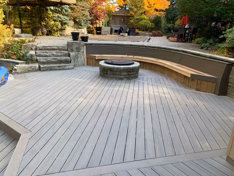 A deck featuring a cozy fire pit and comfortable seating area, perfect for outdoor gatherings and relaxation.