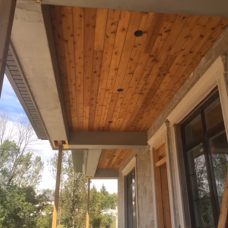 A wooden ceiling with pot lights.