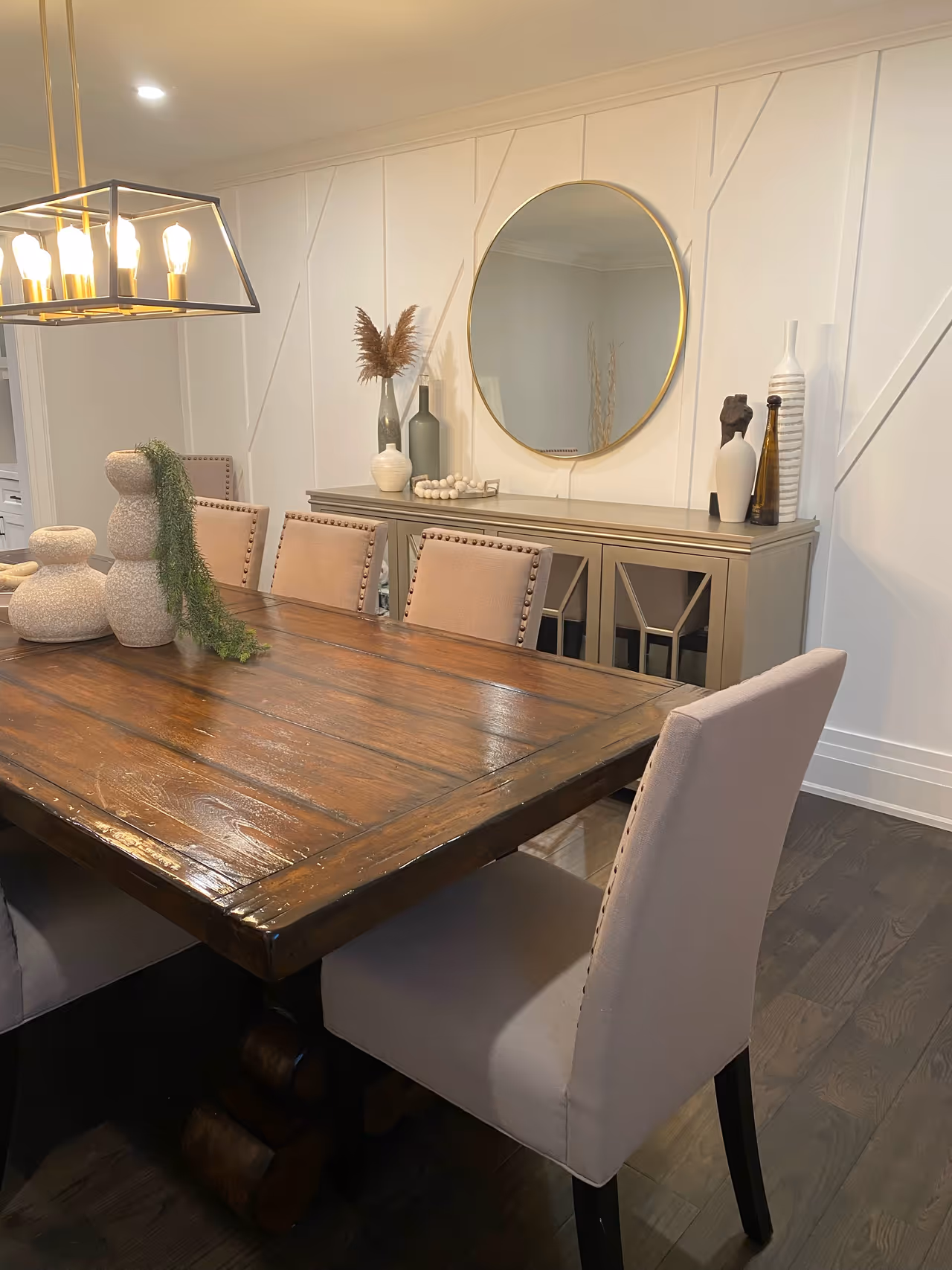 A well-furnished dining room table with chairs and a mirror, creating an elegant and inviting ambiance.