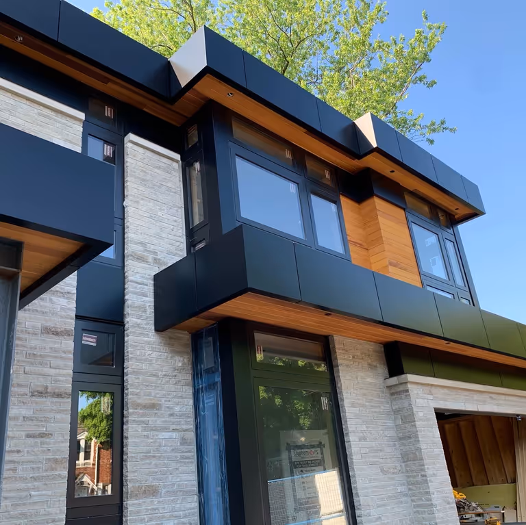 A contemporary house featuring sleek black trim and windows, exuding a modern aesthetic.
